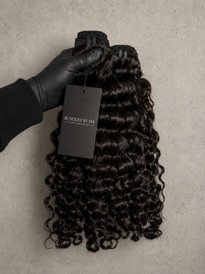 Three bundles of black curly hair extensions from Bundlez by Jay